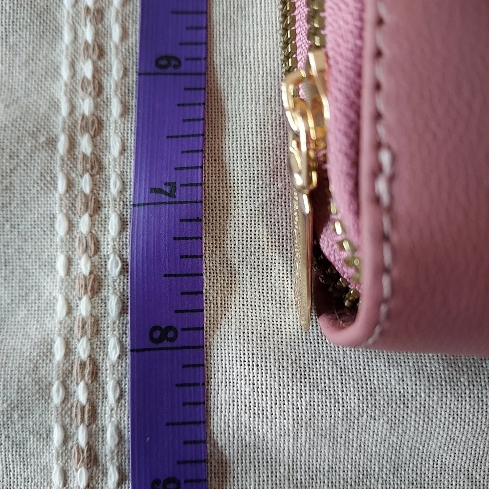 Roulens over shoulder or clutch wallet with cell phone holder.